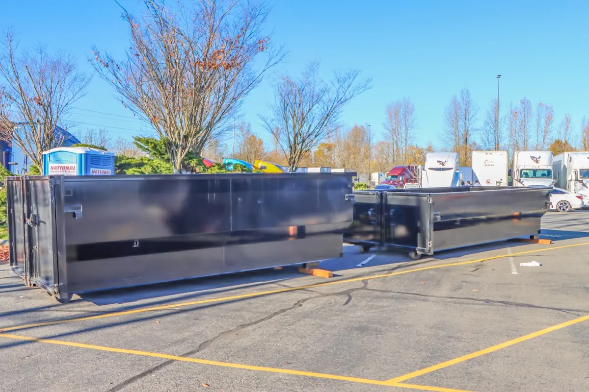 Professional dumpster rental service with roll-off container on residential driveway in Laurel Hill